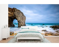 Behang - Fotobehang Stenen - Water - Strand - Rots - Golven - Breedte 295 cm x hoogte 220 cm