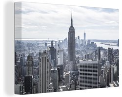 Canvas schilderij 180x120 cm - Wanddecoratie Bewolkte hemel boven het Empire State Building in Amerika - Muurdecoratie woonkamer - Slaapkamer decoratie - Kamer accessoires - Schilderijen