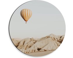 Dibond Muurcirkel - Oranje met Wit Gestreepte Luchtballon Vliegend boven Beige Rotsen - 30x30 cm Foto op Aluminium Muurcirkel (met ophangsysteem)