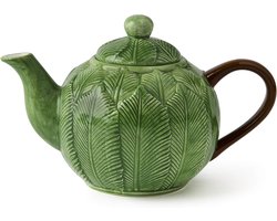 Keramische theepot met gebladerte voor een tropische tafel
