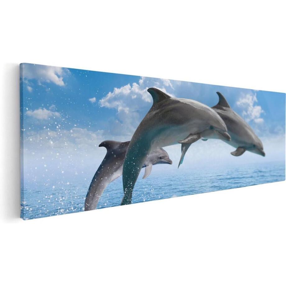 Artaza Canvas Schilderij Dolfijnen Springen uit de Blauwe Zee - 60x20 - Foto Op Canvas - Canvas Print afbeelding 1